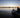 At sunrise, a man launching his inflatable boat to sail