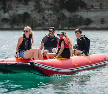 A family on boat journey using their inflatable boat
