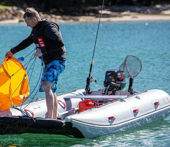 An angler getting ready to fish with all safety equipment in placed in his inflatable boat