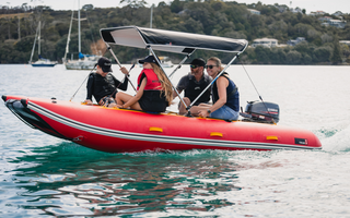 family on a boat with bimini top