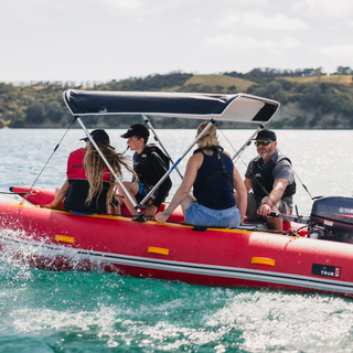 happy family enjoying their ride on an inflatable boat with bimini