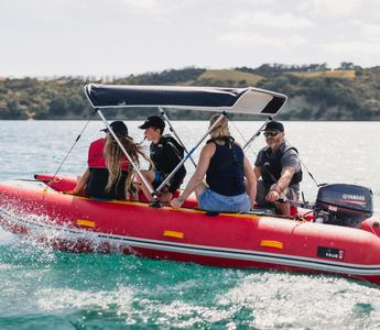 happy family enjoying their ride on an inflatable boat with bimini